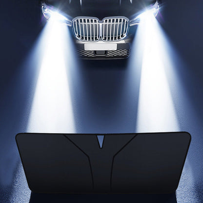 Juoda uždangalo pusė automobilių žibintų šviesoje