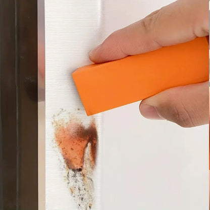 Oranžinis trintukas valo dėmę nuo vertikalaus paviršiaus