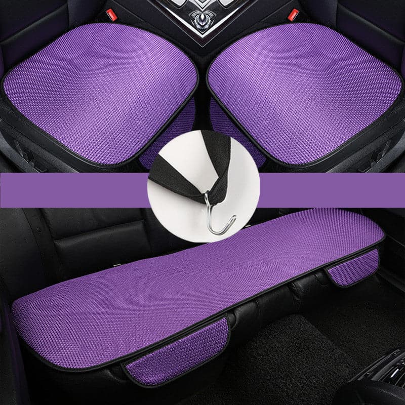 Violet, textured car seat covers with black edges and a hook attachment.