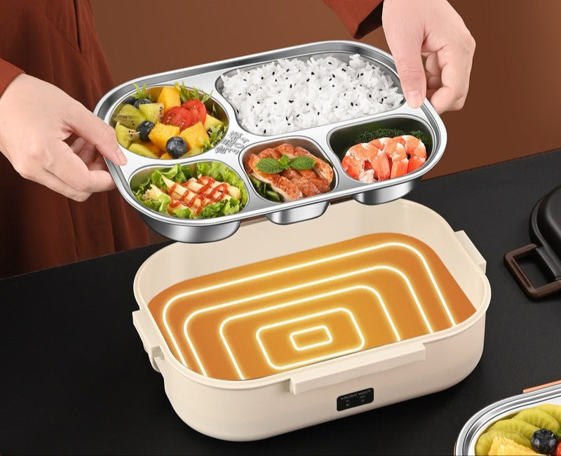 Metalinis maisto indas su įvairių spalvų patiekalais, laikomas rankoje.