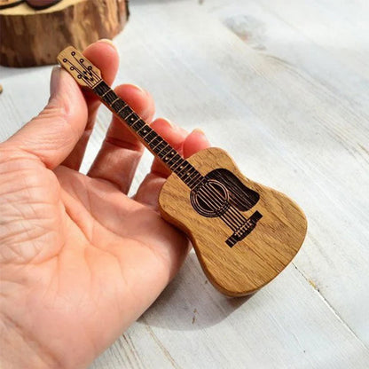 Miniatiūrinis gitaros formos dėklas laikomas rankoje