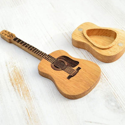 Uždarytas medinis gitaros dėklas šalia mediatorių