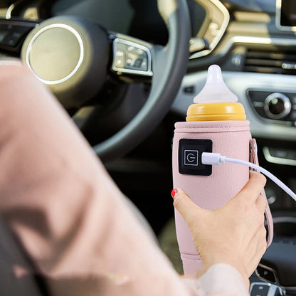 Rožinis buteliuko šildytuvas su USB laidu automobilyje