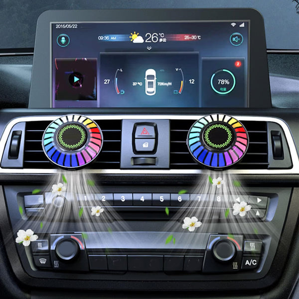 Dvi apvalios spalvotos LED lemputės sumontuotos automobilio centrinėje konsolėje.